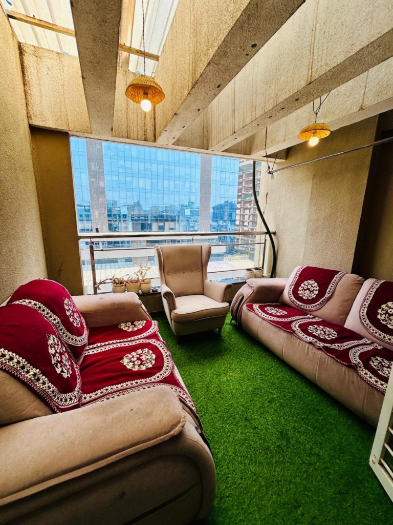 Covered balcony lounge looking toward neighbouring offices