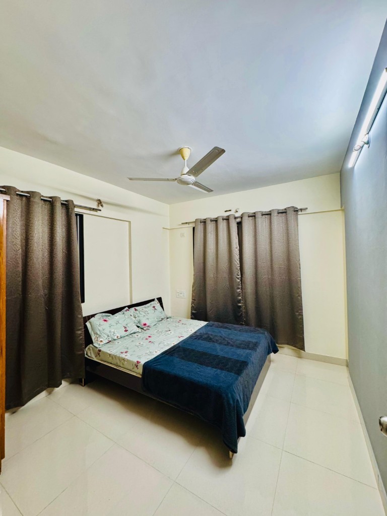 Second bedroom with dual windows and ceiling fan