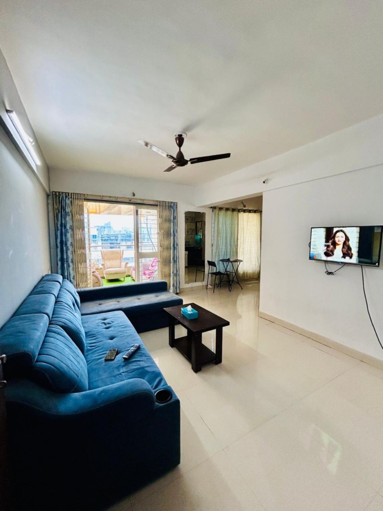 Living space opening onto a furnished balcony